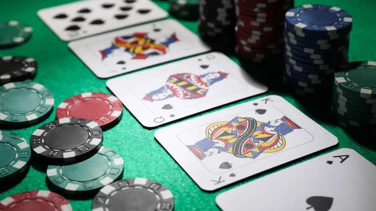 Close-up of poker cards and betting chips, cover image for the PokerBros anti-bot system review